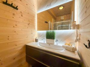 a bathroom with a sink and a mirror at Rattendorf 22A in Rattendorf +22 photos