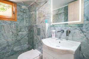 a bathroom with a sink and a toilet and a shower at Lumina House Panagia in Panagia +29 photos