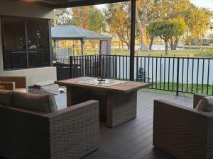 a patio with a wooden table and two chairs at Waterlink Retreat in South Yunderup