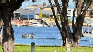 two people in a boat on a body of water at Waterlink Retreat in South Yunderup +13 photos