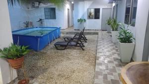 a pool in the middle of a room with plants at HOTEL ALMARr in Coveñas