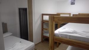 a room with two bunk beds in a room at HOTEL ALMARr in Coveñas