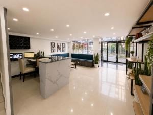 a lobby with a counter and a dining room at Hotel Embajada 44 in Bogotá +28 photos