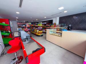 a grocery store with a red chair and a counter at Résidence Oscar - Pool & View in M'diq