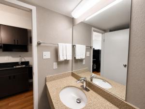 a bathroom with a sink and a mirror at Studio 6 Springfield VA Washington DC Southwest in Springfield +22 photos