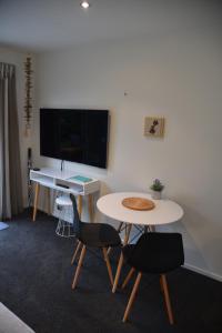 a room with a table and two chairs and a desk at Rojan's Roost in Christchurch