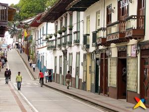 a group of people walking down a street with buildings at Donde Emma in Salamina +12 photos