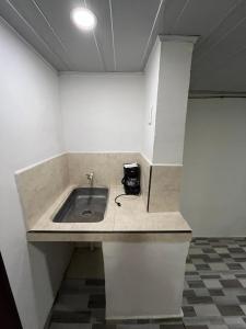 a kitchen counter with a sink in a room at Donde Emma in Salamina