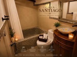 a bathroom with a sink and a toilet and a tub at Casa Santiago Son 2 in Antigua Guatemala