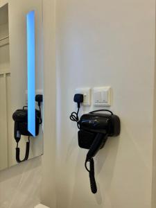 a black phone is hanging on a wall at Olive home in Al Khobar +3 photos