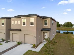 a large house with a garage at Brand New Themed Home With Lake View 11 in Davenport