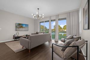 a living room with a couch and chairs and a table at Brand New Themed Home With Lake View 11 in Davenport