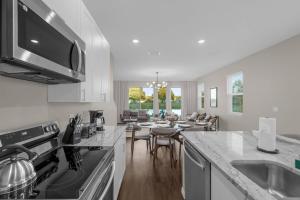 a kitchen with a counter top and a dining room at Brand New Themed Home With Lake View 11 in Davenport