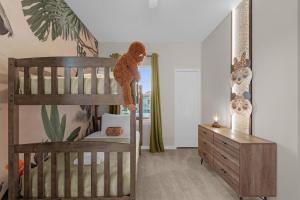 a teddy bear climbing up the ladder of a bunk bed at Brand New Themed Home With Lake View 11 in Davenport