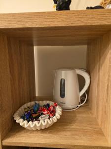 a coffee maker and a plate of candy in a drawer at Hampton Water Rooms Peterborough in Peterborough