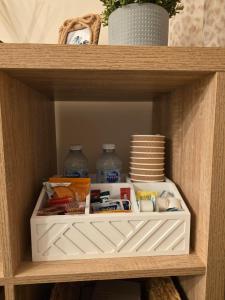 a shelf with food and other items on it at Hampton Water Rooms Peterborough in Peterborough