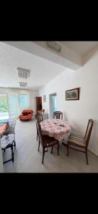 a living room with a table and two chairs at Miković Apartments in Herceg-Novi +2 photos