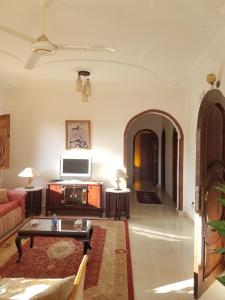 a living room with a couch and a table at Nagar Villa Apartments in Luxor