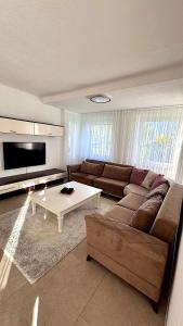 a living room with a couch and a coffee table at Four Rooms Allgäu Apartment in Wangen im Allgäu