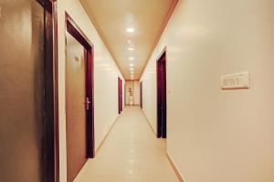 a corridor of an empty hallway in a building at Collection O One Hotel in Ghaziabad
