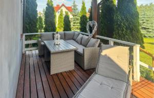 a patio with a couch and a table on a deck at Gorgeous Home In Rybical With Wifi in Rybical