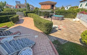 a backyard with a golf cart on a patio at Cozy Home In Capaccio in Foce del Sele