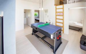 a ping pong table in a room with a bedroom at Gorgeous Home In Odder With Wifi in Odder