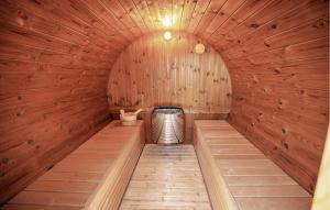 a sauna with a wooden wall and a circular room at Gorgeous Home In Odder With Wifi in Odder +15 photos