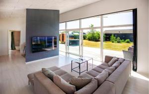 a living room with a couch and a large window at Gorgeous Home In Odder With Wifi in Odder
