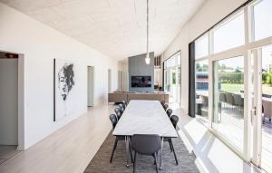 a dining room with a long table and chairs at Gorgeous Home In Odder With Wifi in Odder