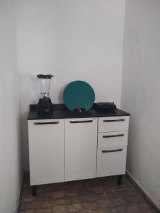 a white cabinet with a blender on top of it at Rosane's casa in Guapimirim