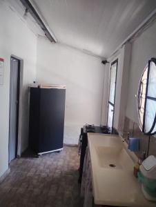 a kitchen with a refrigerator in a room at Rosane's casa in Guapimirim +5 photos
