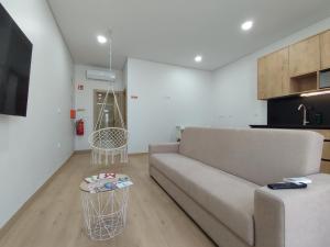 a living room with a couch and a table at Barcelos Habadia Adega in Lijó