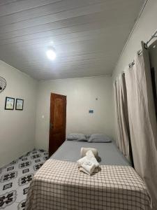 a bedroom with a bed with a towel on it at Cantinho do Romeu in Soure