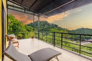 a balcony with a view of the mountains at Vista del Pacifico Boutique Hotel in Quepos