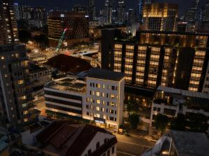 an aerial view of a city at night at Aura Hotel Mackenzie in Singapore