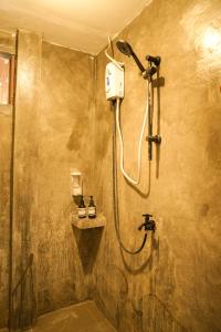 a bathroom with a shower with a shower at Ozen Freediving Hostel in General Luna