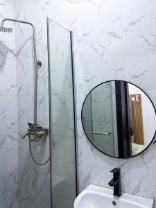 a bathroom with a mirror and a sink at Oak Atlantic Layout - OTITO Suites in Lekki