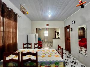 a bedroom with a bed and a kitchen with a refrigerator at Cantinho do Romeu in Soure