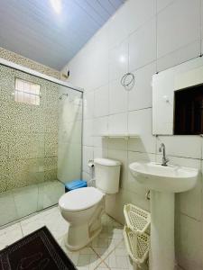 a bathroom with a toilet and a sink at Cantinho do Romeu in Soure +5 photos