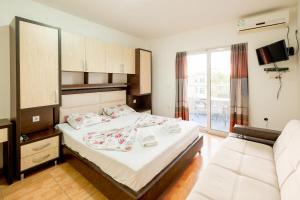 a hotel room with a bed and a couch at Aparthotel Noldina in Donji Štoj