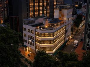 a building with lights on in a city at night at Aura Hotel Mackenzie in Singapore