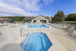 a large swimming pool with chairs at Summit Retreat Seven Springs in Champion