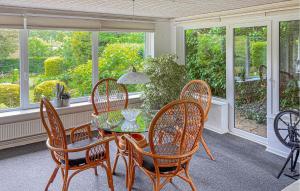 a dining room with a glass table and chairs at 2 Bedroom Pet Friendly Home In Ringkøbing in Ringkøbing