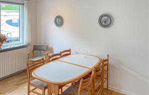 a dining room table and chairs in a room at 2 Bedroom Pet Friendly Home In Ringkøbing in Ringkøbing