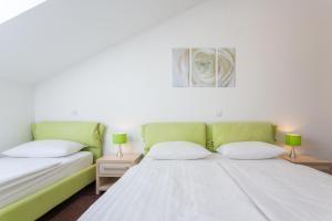 Posteľ alebo postele v izbe v ubytovaní Apartments Villa Alba