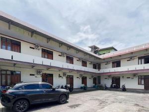 a car parked in front of a building at RedDoorz @ Malalayang Manado in Manado
