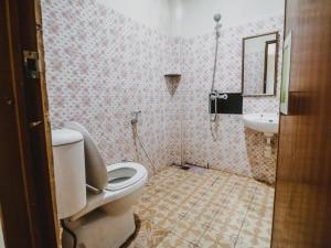 a bathroom with a toilet and a sink at RedDoorz @ Malalayang Manado in Manado