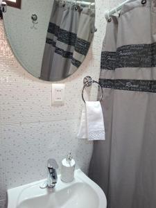 a bathroom with a sink and a mirror at Alto Jere in Toconao