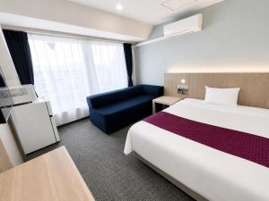 a hotel room with a bed and a couch at Hotel 21 in Kusatsu +15 photos